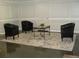 Apartment building lobby area with slate flooring, leather chairs, glass table and neutral walls at 2965 Pharr Court South Nw # 110, Atlanta, GA 30305