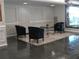 Lobby area with slate flooring, three black leather chairs and a glass table at 2965 Pharr Court South Nw # 110, Atlanta, GA 30305