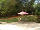 Relaxing outdoor seating area featuring a red umbrella and a nearby walking path at 2965 Pharr Court South Nw # 110, Atlanta, GA 30305