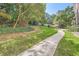 Landscaped walkway leading to a community area with tables, chairs, and mature trees at 2965 Pharr Court South Nw # 110, Atlanta, GA 30305