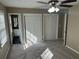 This bedroom features neutral walls, carpet, and a ceiling fan with light, creating a cozy space at 4502 Cherie Glen Trl, Stone Mountain, GA 30083