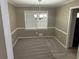 Cozy dining room features a window for natural light, neutral walls and carpeting at 4502 Cherie Glen Trl, Stone Mountain, GA 30083