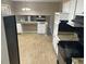 Well-lit kitchen with white cabinets, black appliances and black tiled backsplash at 4502 Cherie Glen Trl, Stone Mountain, GA 30083