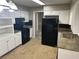 Functional kitchen with black appliances, ample cabinet space and neutral countertops at 4502 Cherie Glen Trl, Stone Mountain, GA 30083