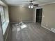 Sunlit living room with a ceiling fan, neutral color palette and plush carpeting at 4502 Cherie Glen Trl, Stone Mountain, GA 30083