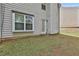 Backyard view of the grassy lawn and exterior of the house at 4607 Ravenwood Loop, Union City, GA 30291