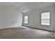 Bedroom with neutral walls and carpet, and two windows which provide ample natural light at 4607 Ravenwood Loop, Union City, GA 30291