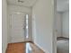 Bright entryway featuring hardwood floors and a view into an adjacent carpeted room at 4607 Ravenwood Loop, Union City, GA 30291