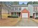 Charming townhome featuring brick accents, an attached garage, and a well-maintained front yard at 4607 Ravenwood Loop, Union City, GA 30291