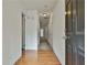 View of the hallway featuring hardwood floors and multiple doors leading to other rooms at 4607 Ravenwood Loop, Union City, GA 30291