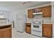 Kitchen featuring classic cabinets, white appliances, and a checkered floor at 4607 Ravenwood Loop, Union City, GA 30291