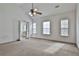 Spacious main bedroom with a ceiling fan and lots of natural light coming through the windows at 4607 Ravenwood Loop, Union City, GA 30291