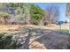 Wide-angle view of the spacious backyard filled with mature trees and a satellite dish at 11941 Fairway Overlook, Fayetteville, GA 30215