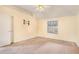 A bedroom with cream walls and carpet with a ceiling fan and one window at 11941 Fairway Overlook, Fayetteville, GA 30215