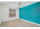 A bedroom with white and teal walls and carpet with a ceiling fan and one window at 11941 Fairway Overlook, Fayetteville, GA 30215