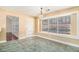 Bright dining area with a chandelier, tiled floor, and door to the backyard at 11941 Fairway Overlook, Fayetteville, GA 30215