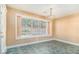 Cozy dining area with a chandelier and a large window overlooking the backyard at 11941 Fairway Overlook, Fayetteville, GA 30215