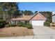Charming one-story brick home featuring a two-car garage and mature landscaping at 11941 Fairway Overlook, Fayetteville, GA 30215