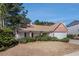 Charming brick accent home with a two-car garage, covered porch, and mature landscaping at 11941 Fairway Overlook, Fayetteville, GA 30215