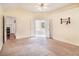 A large main bedroom with cream walls and carpet with a ceiling fan, doors to bath, and fireplace view at 11941 Fairway Overlook, Fayetteville, GA 30215