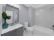 Beautiful bathroom featuring a modern vanity, decorative floors, bathtub, and a sleek shower head at 1115 Mcgill Park Ne Ave, Atlanta, GA 30312