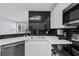 Well-lit kitchen featuring white cabinets and trendy black backsplash at 1115 Mcgill Park Ne Ave, Atlanta, GA 30312