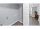 The laundry room has gray walls and flooring and is connected to the main bedroom at 1115 Mcgill Park Ne Ave, Atlanta, GA 30312