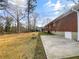 Expansive backyard featuring lush lawn, mature trees, and the property's brick exterior at 1742 Mural Dr, Morrow, GA 30260