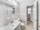 Clean and bright bathroom featuring white fixtures, tiled walls, and a well-lit vanity area at 1742 Mural Dr, Morrow, GA 30260