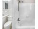 Bright, clean bathroom featuring a combination bathtub and shower with white tiled walls at 1742 Mural Dr, Morrow, GA 30260