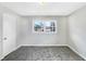 Bright bedroom with carpet and neutral walls, highlighted by a window offering natural light and street views at 1742 Mural Dr, Morrow, GA 30260