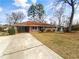 Charming single-story home featuring a brick facade, covered carport, and well-maintained landscaping at 1742 Mural Dr, Morrow, GA 30260