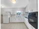 Functional kitchen featuring white cabinetry, ample counter space, and essential appliances at 1742 Mural Dr, Morrow, GA 30260