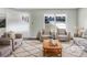 Bright and airy living room with neutral tones, large windows, and comfortable seating arrangements at 1742 Mural Dr, Morrow, GA 30260