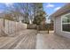 Fenced backyard featuring wood deck, gate, and stone pavers at 3177 Shadow Walk Ln, Tucker, GA 30084