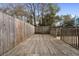 Fenced backyard with wood deck and access gate at 3177 Shadow Walk Ln, Tucker, GA 30084