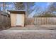 Fenced backyard featuring wood shed, wood deck, and stone pavers at 3177 Shadow Walk Ln, Tucker, GA 30084