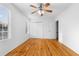 Large bedroom features wood flooring, a ceiling fan, double closet, and bright windows at 3177 Shadow Walk Ln, Tucker, GA 30084