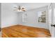 Bedroom with wood floors, a ceiling fan, large window, and neutral walls at 3177 Shadow Walk Ln, Tucker, GA 30084