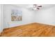 Bright bedroom featuring hardwood floors, white walls, a ceiling fan, and a window at 3177 Shadow Walk Ln, Tucker, GA 30084