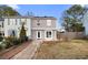 Charming townhouse with a well-manicured lawn and inviting walkway to the front door at 3177 Shadow Walk Ln, Tucker, GA 30084