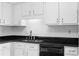 Clean kitchen featuring white cabinets, subway tile backsplash, black counters, and black dishwasher at 3177 Shadow Walk Ln, Tucker, GA 30084