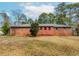 Brick home featuring a flat, grassy backyard with mature trees offering both shade and privacy at 3951 Lindley Dr, Powder Springs, GA 30127