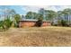 A sprawling backyard with a brick house with mature trees at 3951 Lindley Dr, Powder Springs, GA 30127