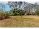 The expansive backyard with its lush lawn and mature trees providing privacy and plenty of space for recreation at 3951 Lindley Dr, Powder Springs, GA 30127