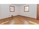 A bedroom with hardwood flooring, natural light from two windows, and neutral-colored walls at 3951 Lindley Dr, Powder Springs, GA 30127