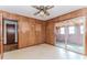 Bedroom featuring wood paneling, linoleum floors, and sliding glass doors at 3951 Lindley Dr, Powder Springs, GA 30127