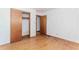 Bedroom featuring hardwood floors, a sliding door closet and standard wooden door at 3951 Lindley Dr, Powder Springs, GA 30127