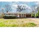 Charming one-story brick home with a covered carport and well-maintained landscaping in a suburban neighborhood at 3951 Lindley Dr, Powder Springs, GA 30127