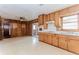 Kitchen and attached room featuring wood paneling, linoleum floors, a ceiling fan and sliding glass doors at 3951 Lindley Dr, Powder Springs, GA 30127